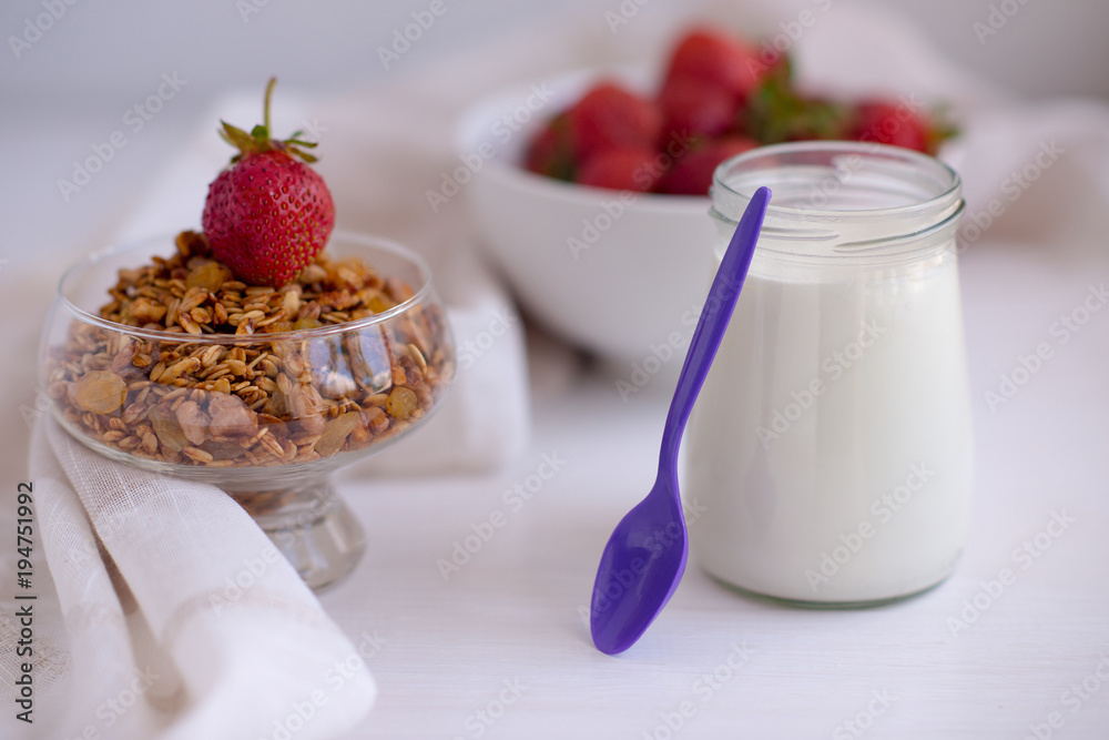 Homemade granola in jar on rustic kitchen table, healthy breakfa Homemade granola in jar on rustic kitchen table, healthy breakfa