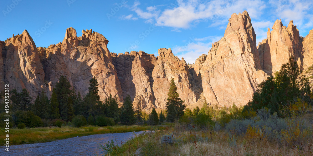 Dramatic natural formation panoramic view during the golden hour at sunset in Smith Rock State Park in Eastern Oregon USA Pacific Northwest.