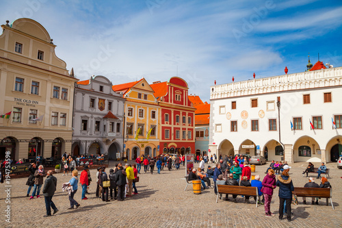 CESKY KRUMLOV, CZECH REPUBLIC - APLIR 23, 2017: Colorful buildings and tourists walking by main square