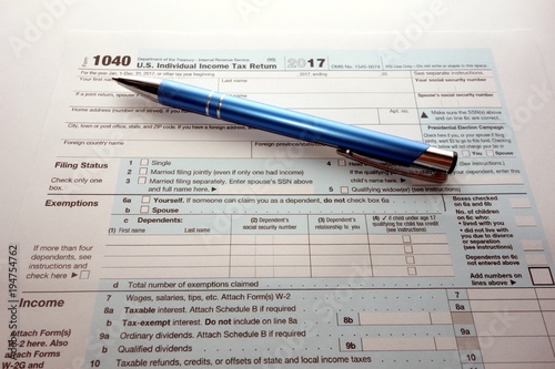 US form 1040 for year 2017 and pen, tax time concept
