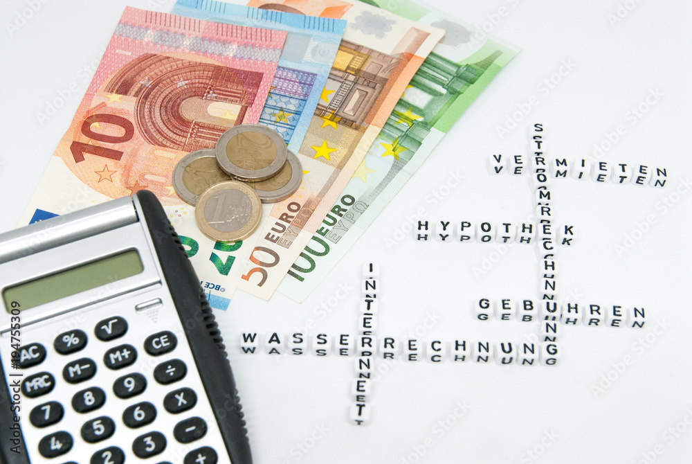 euro and calculator and words written in german representing household monthly expenses concept photo euro and calculator and words written in german representing household monthly expenses concept photo
