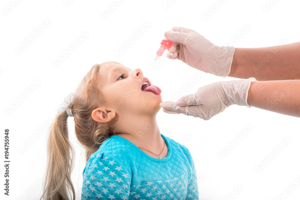 little girl on reception at the doctor receives the polio vaccine, a child being treated for influenza, the child takes the medicine in the hospitalception at the doctor takes antipyretic, anti-flu