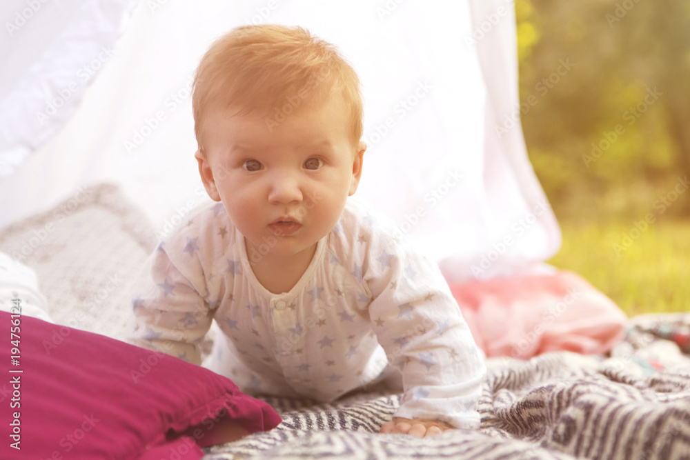 Little newborn infant baby boy kid on a plaid in park. Summer sunset. Copy space Little newborn infant baby boy kid on a plaid in park. Summer sunset. Copy space