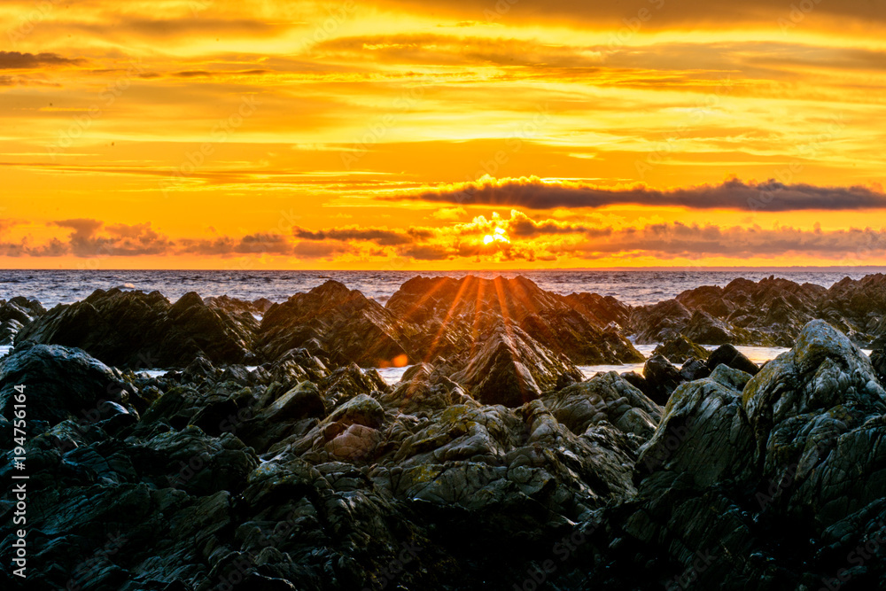 sunset over rocky sea