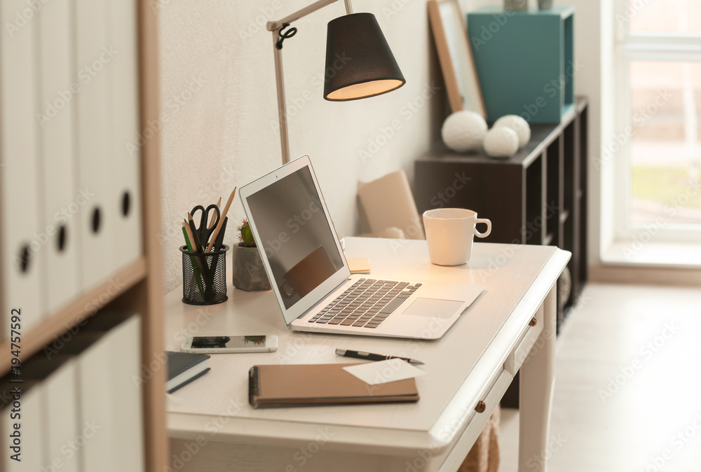 Comfortable workplace with laptop on desk Comfortable workplace with laptop on desk