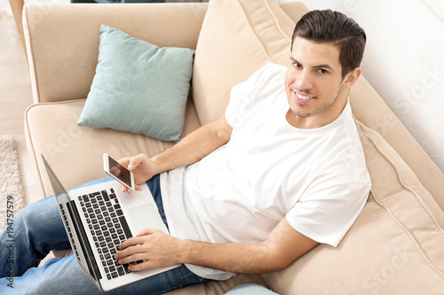 Young man using smartphone ...