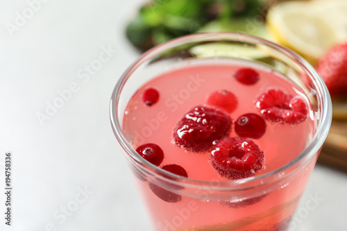 Glass of fresh lemonade with berries, closeup