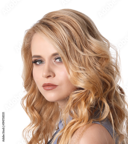 Beautiful young woman with long wavy hair on white background