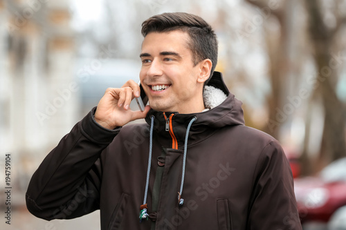 Young man talking on phone ...