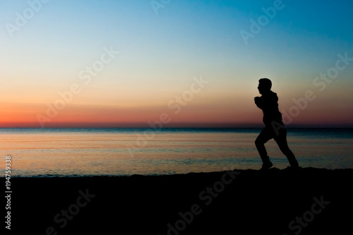 Silhouette of runner old man in the morning at the beach  sunrise Background.
