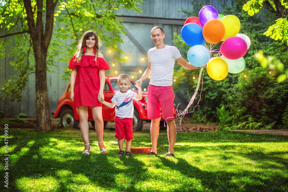 Obraz premium Happy young family having fun together in summer park