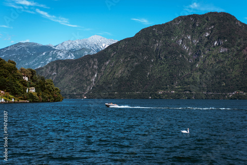Amazing view of bright blue Como lake, Lombardy Italy, panorama of the lake and the city. Mountains on the background and good sunny summer weather © ANR Production