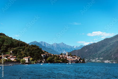 Amazing view of bright blue Como lake, Lombardy Italy, panorama of the lake and the city. Mountains on the background and good sunny summer weather