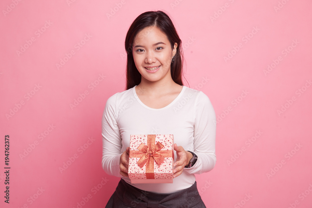 Young Asian woman with a gift box. Young Asian woman with a gift box.