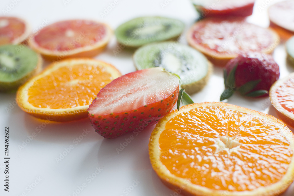 Close-up background with kiwi, orange, strawberry, tangerine Close-up background with kiwi, orange, strawberry, tangerine