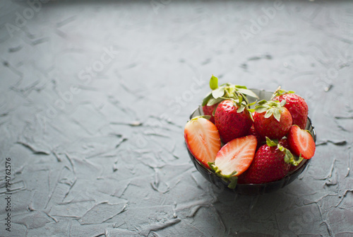 Horizontally background with cup of strawberry on dark blue background photo