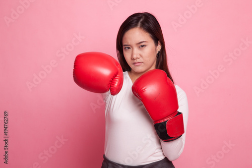 Young Asian woman with red boxing gloves. © halfbottle