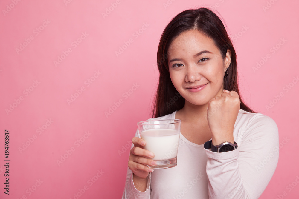Healthy Asian woman drinking a glass of milk. Healthy Asian woman drinking a glass of milk.