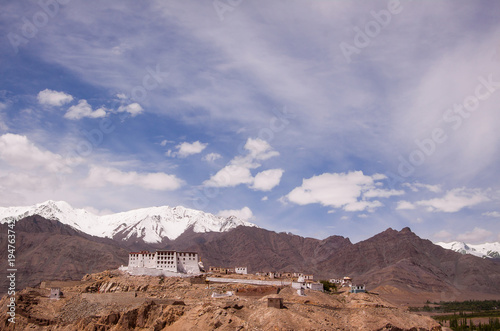 Scenic view on ancient buddhist monastery in himalayas with snowy mountains background. Region Ladakh. India. State Jammu and Kashmir.