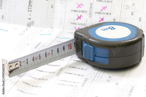 Construction blueprints with tools and measuring tape, roulette, closeup. With place for rext