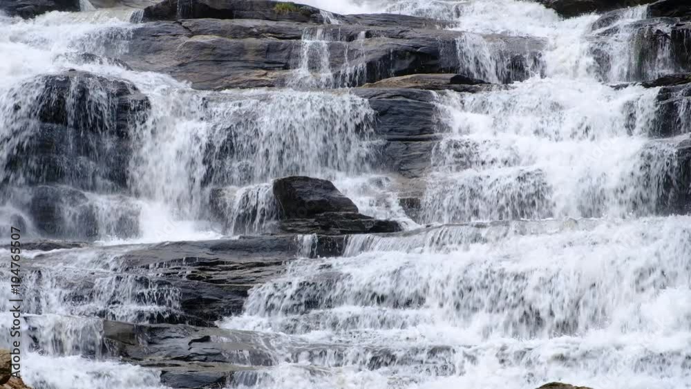 Close up.Pure fresh water waterfall in forest with black rocks. Close up.Pure fresh water waterfall in forest with black rocks.