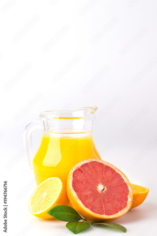 Fresh orange juice and citrus fruits lime lemon grapefruit in a jar white background healthy concept Fresh orange juice and citrus fruits lime lemon grapefruit in a jar white background healthy concept