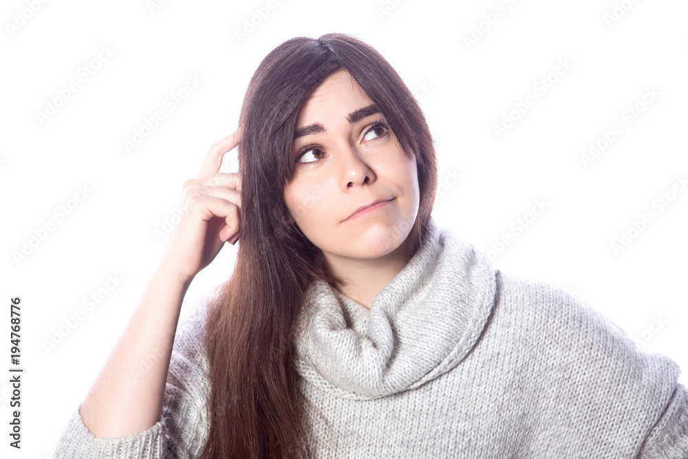 Cute teenage girl with long dark hair standing on a white background in grey oversize sweater. Emotional lifestyle portrait Cute teenage girl with long dark hair standing on a white background in grey oversize sweater. Emotional lifestyle portrait