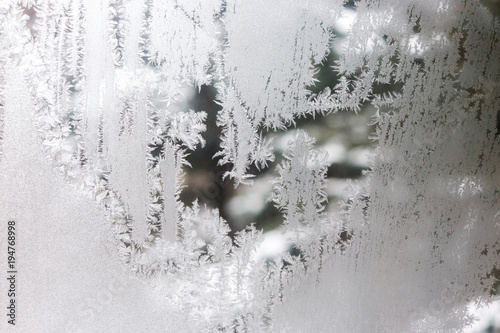 frostwork on frozen window symbolizes winter and cold, close up