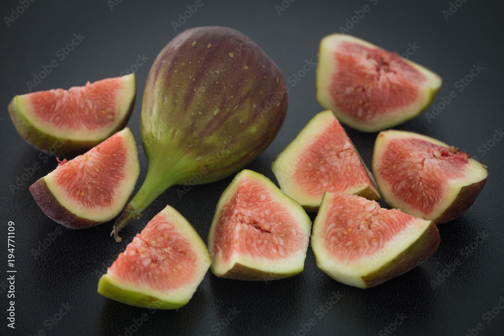 Figs fruits on the dark stone background. Figs fruits on the dark stone background.