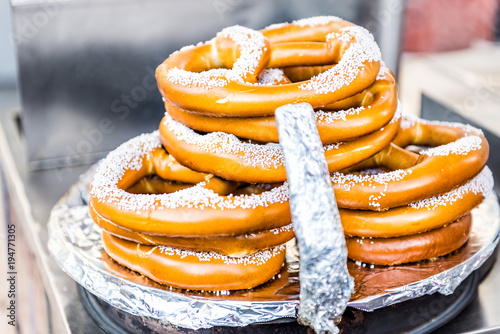 Canvas Print Closeup of pile stack of fresh cooked pretzels, salt or sugar by food truck in N