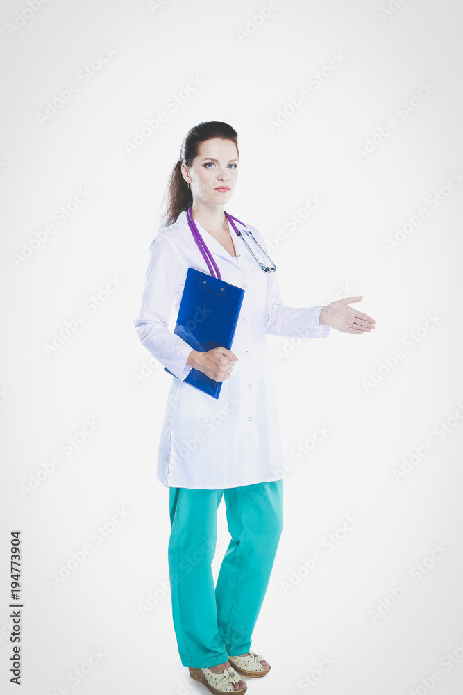 Smiling female doctor with a folder in uniform standing at hospital. Smiling female doctor Smiling female doctor with a folder in uniform standing at hospital. Smiling female doctor