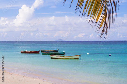 old fisherman boats moored near sandy beach on Mauritius island