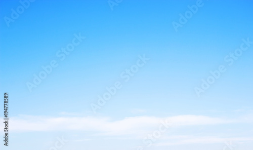 Blue sky background and white clouds soft focus, and copy-space