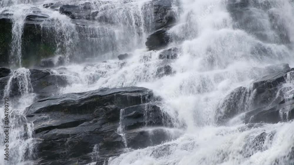 Close up.Pure fresh water waterfall in forest with black rocks. Close up.Pure fresh water waterfall in forest with black rocks.