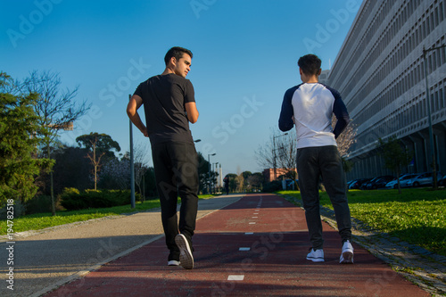two young man in sport clothes running