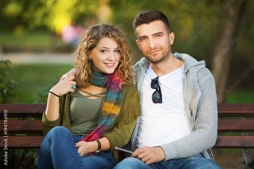 Fototapeta premium Young couple in park hugging