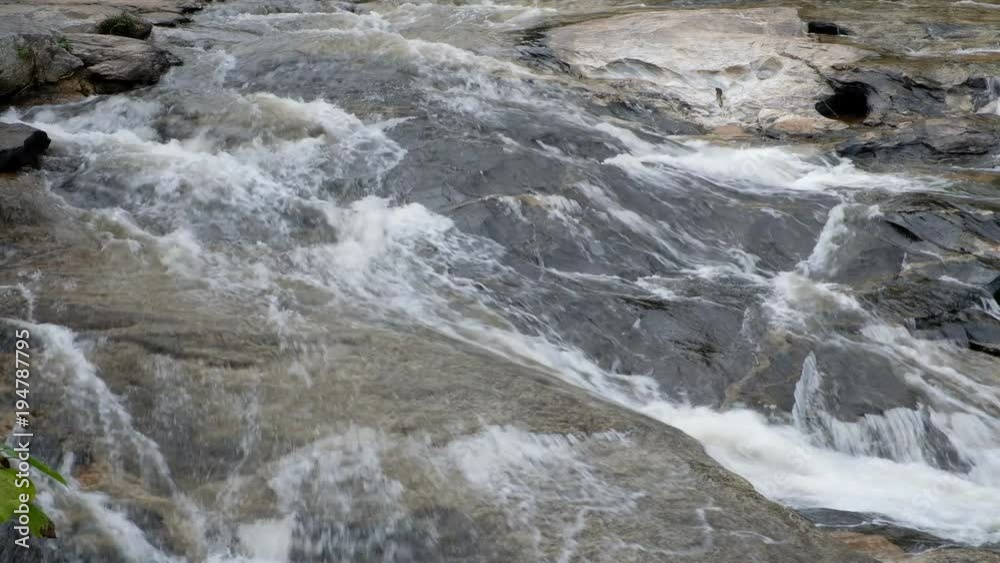 Close up.Pure fresh water waterfall in forest with black rocks. Close up.Pure fresh water waterfall in forest with black rocks.