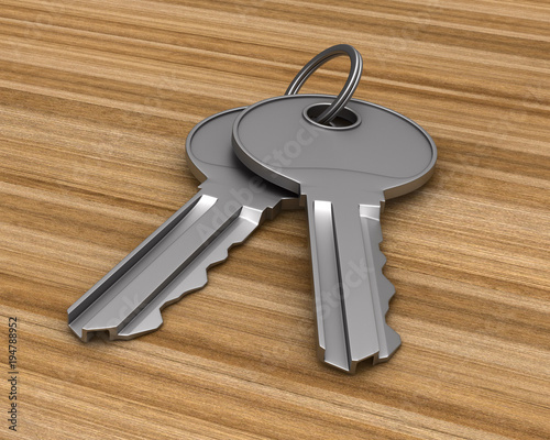 Two metallic keys on wooden...