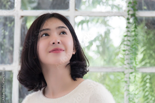 Free Download Beautiful asian teenage in green garden is looking something at upper side - GFXLoad