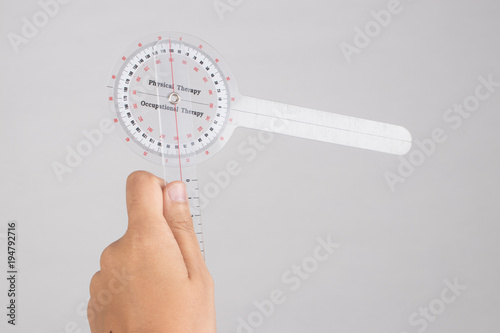 physiotherapist holding a goniometer for measuring range of motion isolated on white background.