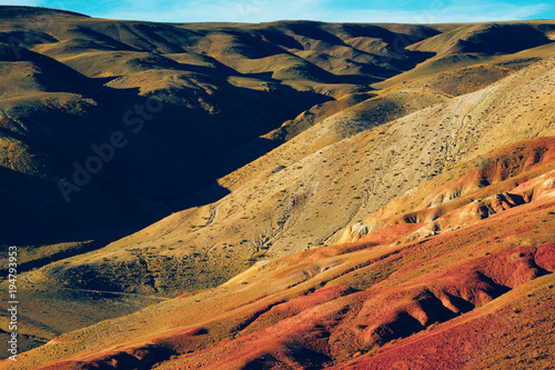Colorful red hills and canyons in pastel colors. Autumn mood of nature, travel through the mountains of Altai.
