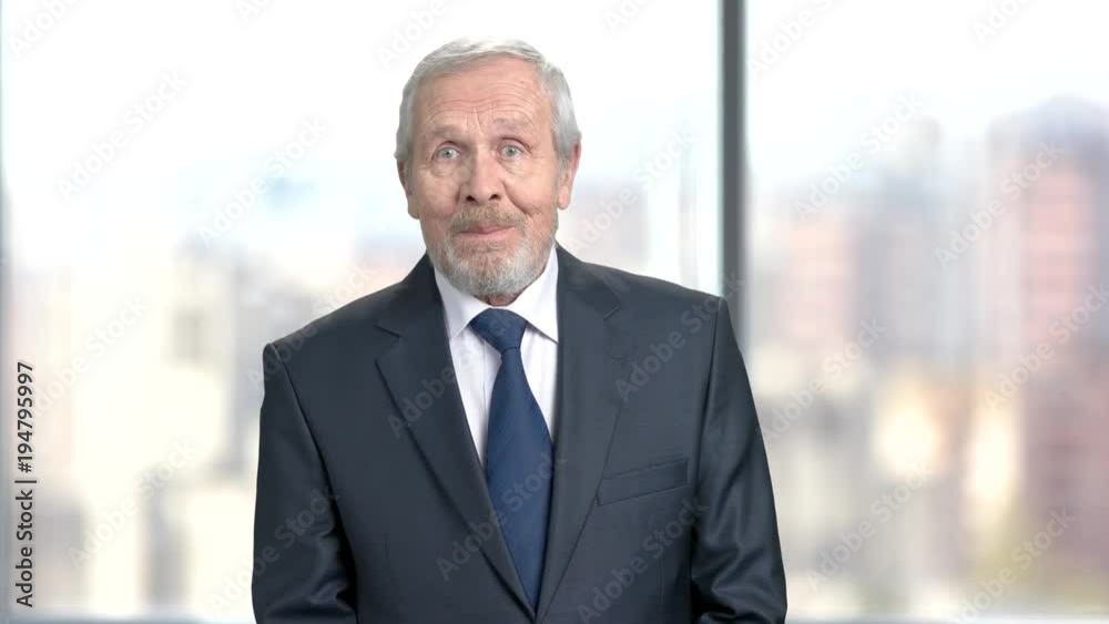 Happy shocked businessman on blurred background. Aged man in formal wear clenched fists in excitement, blurred background. Expressions of joy. Happy shocked businessman on blurred background. Aged man in formal wear clenched fists in excitement, blurred background. Expressions of joy.