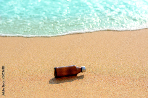 Glass bottles on the beach and blue sea background