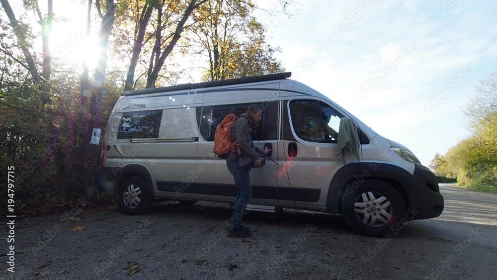 Traveling vlogger leaving conversion van for hike in woods of Eifel Germany Traveling vlogger leaving conversion van for hike in woods of Eifel Germany