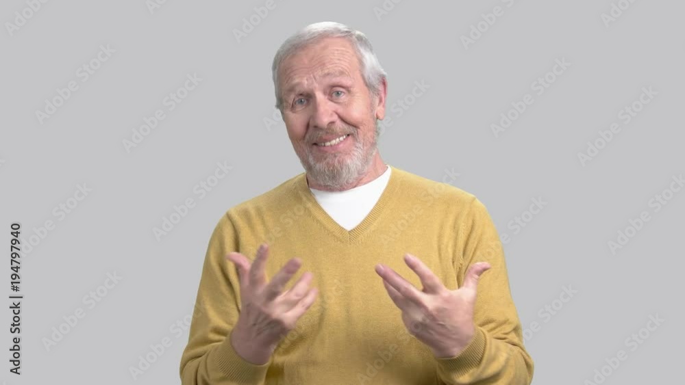Smiling elderly man talking at camera. Speech of senior man at meeting. Aged man sharing with experience to audience. Smiling elderly man talking at camera. Speech of senior man at meeting. Aged man sharing with experience to audience.