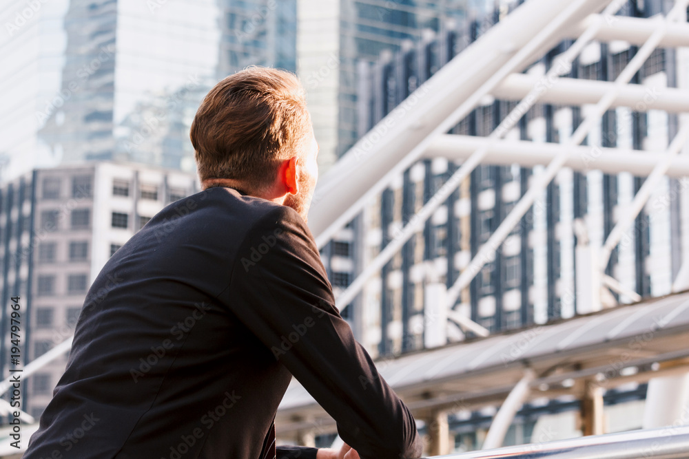 Portrait of handsome man in black suit standing outdoors Portrait of handsome man in black suit standing outdoors