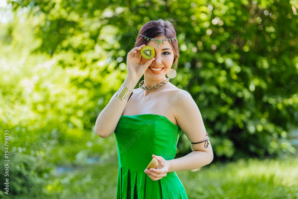 Beautiful young asian woman with kiwi