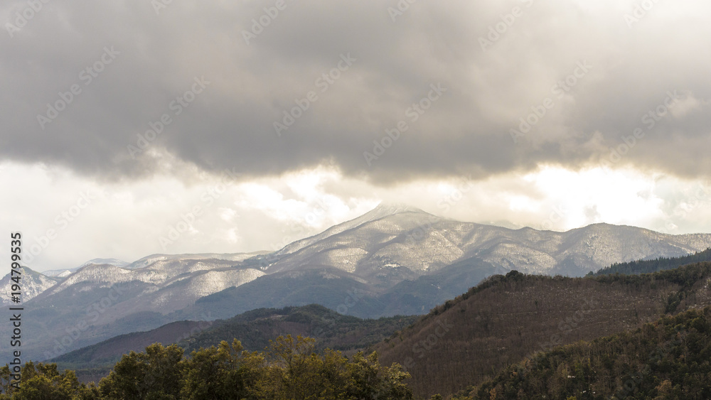 Snowy mountain peaks on a winter cloudscape Snowy mountain peaks on a winter cloudscape