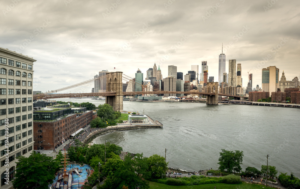 Brooklyn Bridge and New York City Skyline under Stormy Skies