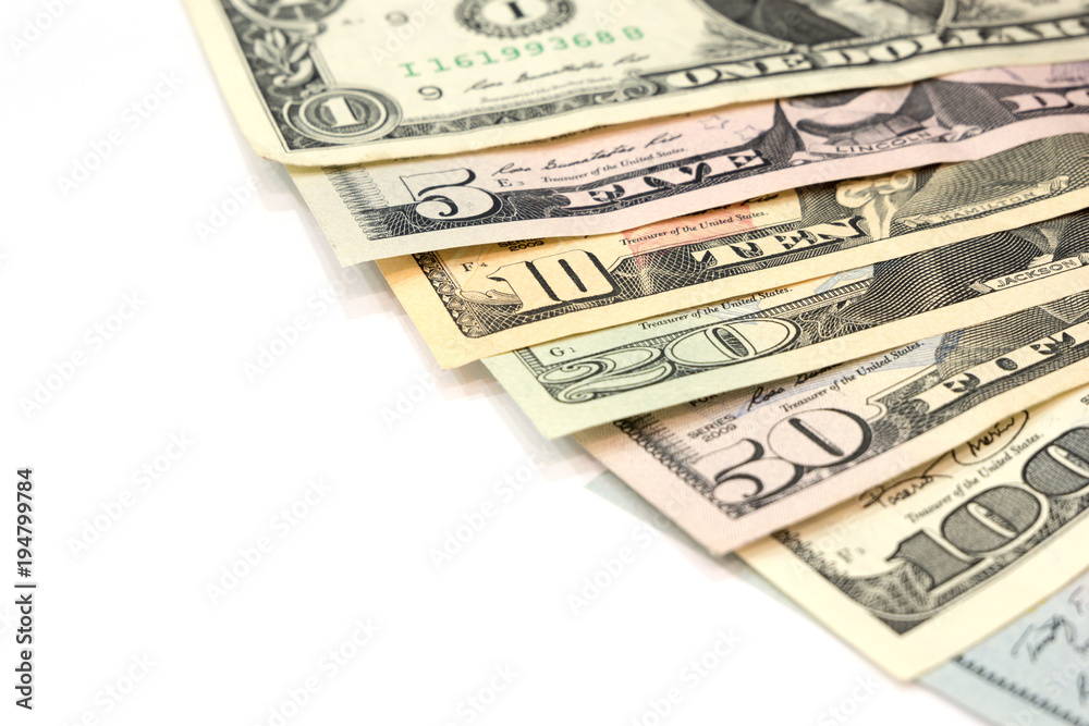 Pile of various US american dollar money bills spread as fan sorted by value of dollar banknotes on white background. Pile of various US american dollar money bills spread as fan sorted by value of dollar banknotes on white background.